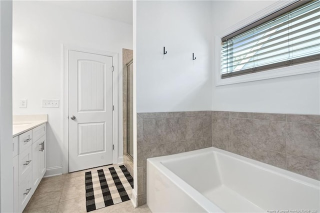 25 Vast View Way, Youngsville, NC 27596 - bathroom featuring a garden tub, vanity, a stall shower, and tile patterned flooring