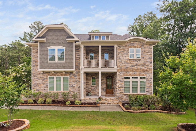 728 Peninsula Forest Pl, Cary, NC 27519 - view of front of home with a balcony, stone siding, and a front yard