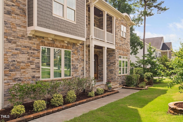 728 Peninsula Forest Pl, Cary, NC 27519 - entrance to property featuring a balcony, stone siding, and a lawn