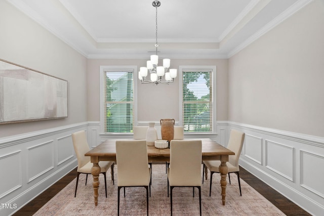 728 Peninsula Forest Pl, Cary, NC 27519 - dining space with dark wood-type flooring, healthy amount of natural light, a chandelier, a tray ceiling, and a wainscoted wall
