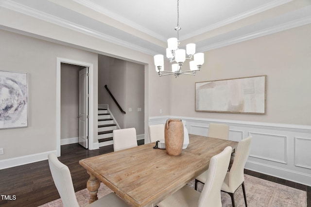 728 Peninsula Forest Pl, Cary, NC 27519 - dining space with a chandelier, stairway, dark wood-style floors, ornamental molding, and a wainscoted wall
