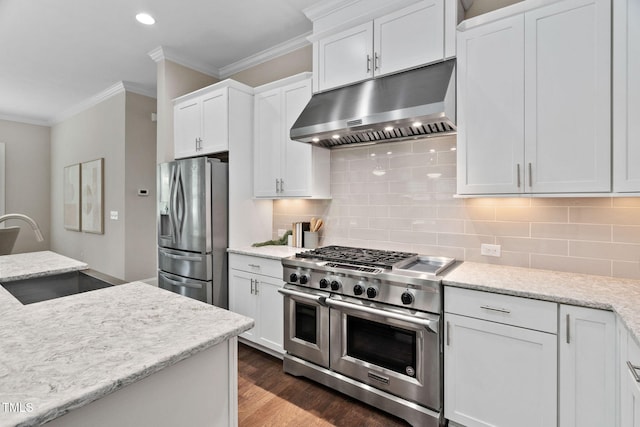 728 Peninsula Forest Pl, Cary, NC 27519 - kitchen featuring under cabinet range hood, stainless steel appliances, crown molding, white cabinets, and decorative backsplash