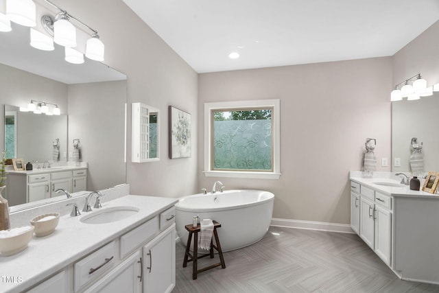 728 Peninsula Forest Pl, Cary, NC 27519 - bathroom with two vanities, a soaking tub, and recessed lighting