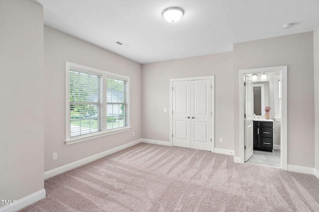 728 Peninsula Forest Pl, Cary, NC 27519 - unfurnished bedroom with light colored carpet, a closet, and ensuite bathroom