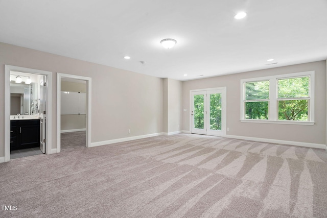 728 Peninsula Forest Pl, Cary, NC 27519 - unfurnished bedroom with light colored carpet, recessed lighting, ensuite bath, and access to exterior