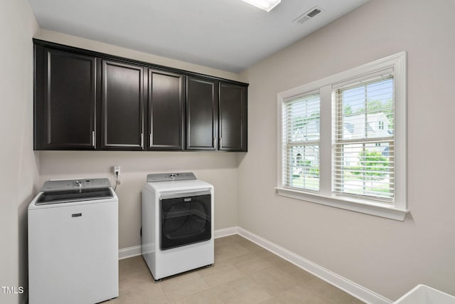 728 Peninsula Forest Pl, Cary, NC 27519 - laundry area featuring independent washer and dryer, cabinet space, and light tile patterned floors