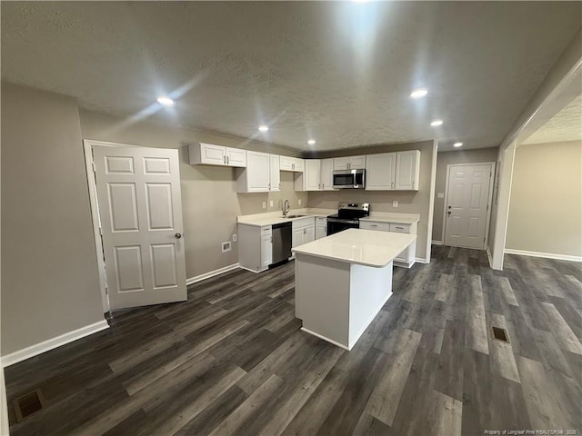 2903 Peacock St, Hope Mills, NC 28348 - kitchen with appliances with stainless steel finishes, baseboards, dark wood-style flooring, recessed lighting, and white cabinetry