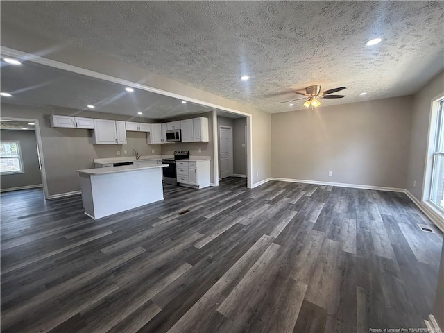 2903 Peacock St, Hope Mills, NC 28348 - kitchen with appliances with stainless steel finishes, open floor plan, a textured ceiling, ceiling fan, and baseboards