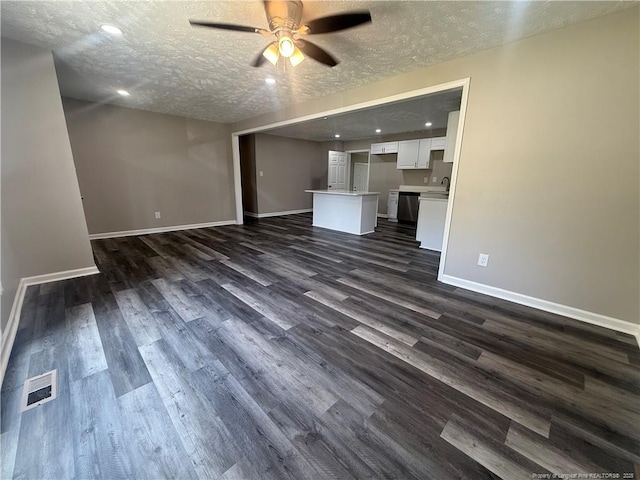 2903 Peacock St, Hope Mills, NC 28348 - unfurnished living room featuring ceiling fan, baseboards, dark wood-style flooring, a textured ceiling, and recessed lighting