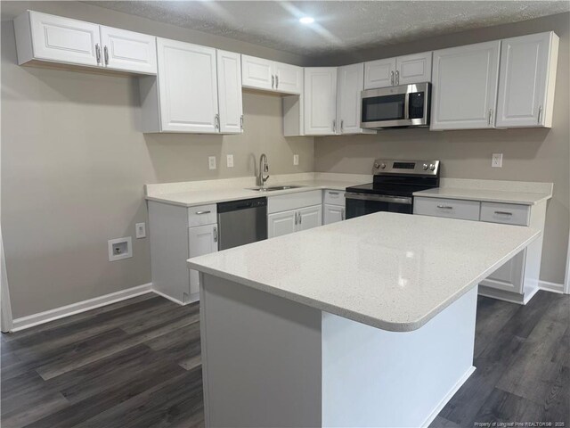 2903 Peacock St, Hope Mills, NC 28348 - kitchen with appliances with stainless steel finishes, a sink, dark wood-style flooring, white cabinets, and recessed lighting