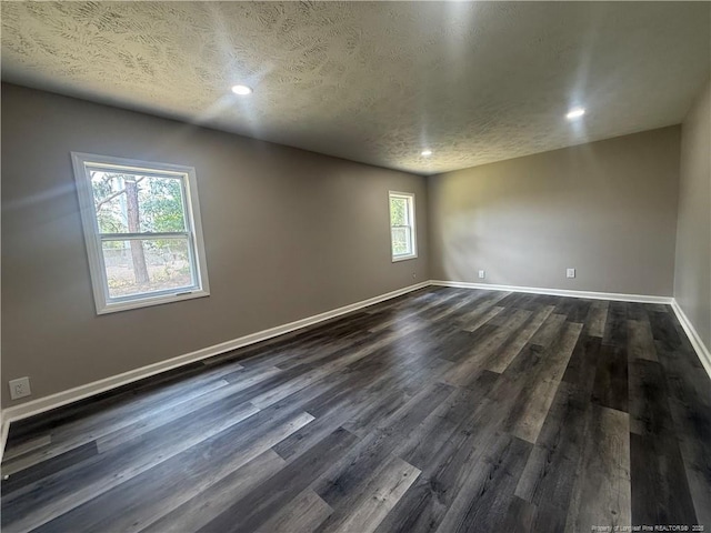 2903 Peacock St, Hope Mills, NC 28348 - empty room featuring dark wood-style flooring, baseboards, recessed lighting, and a textured ceiling
