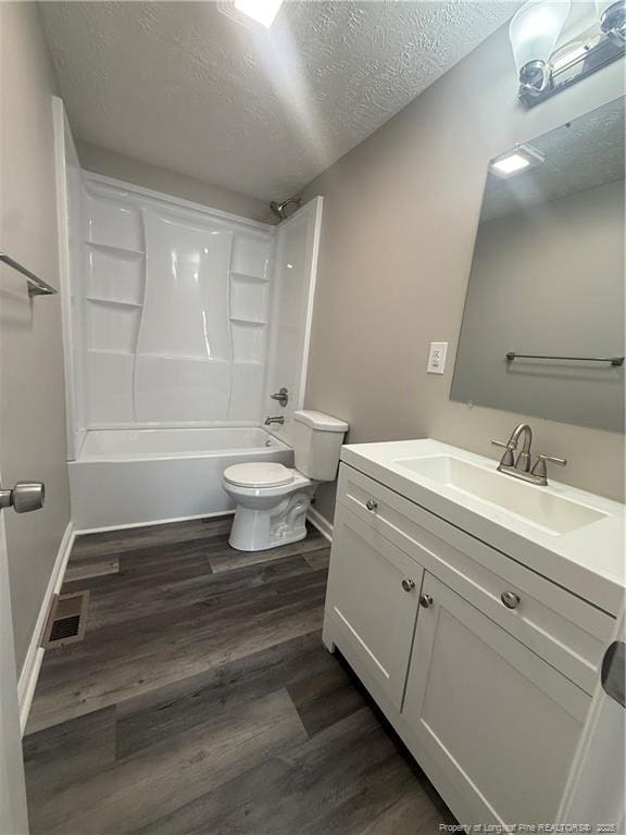 2903 Peacock St, Hope Mills, NC 28348 - full bathroom featuring toilet, vanity, a textured ceiling, wood finished floors, and shower / bath combination