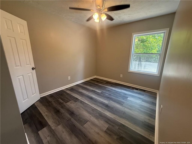2903 Peacock St, Hope Mills, NC 28348 - spare room with a textured ceiling, a ceiling fan, baseboards, and dark wood-type flooring