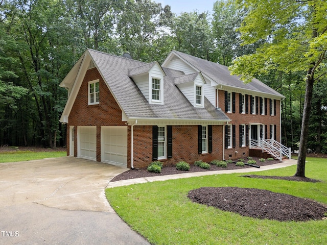 221 Jansmith Ln, Raleigh, NC 27615 - view of front of property featuring brick siding, driveway, a front lawn, a garage, and a shingled roof