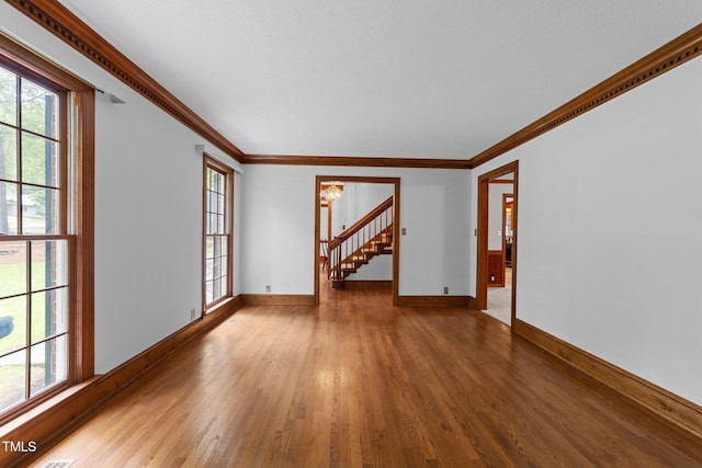221 Jansmith Ln, Raleigh, NC 27615 - unfurnished room with wood finished floors, baseboards, plenty of natural light, and ornamental molding