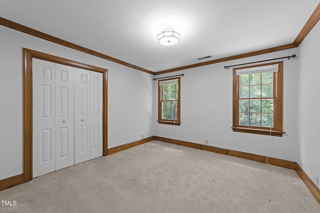221 Jansmith Ln, Raleigh, NC 27615 - unfurnished bedroom with carpet floors, crown molding, baseboards, multiple windows, and a closet
