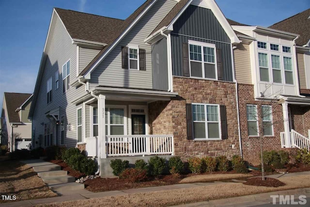 921 Rosepine Dr, Cary, NC 27519 - view of front of home with stone siding, a porch, and board and batten siding