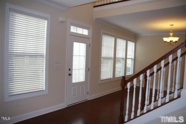 921 Rosepine Dr, Cary, NC 27519 - entrance foyer with a chandelier, ornamental molding, baseboards, stairway, and dark wood-style floors