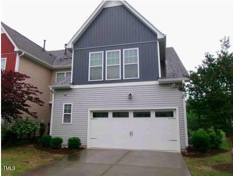 921 Rosepine Dr, Cary, NC 27519 - view of side of home featuring an attached garage, driveway, and board and batten siding