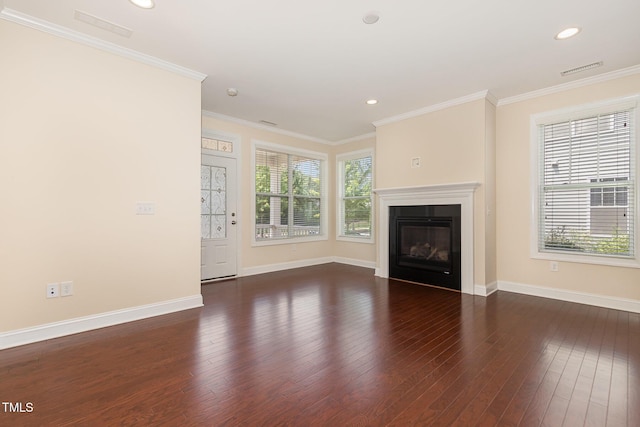 921 Rosepine Dr, Cary, NC 27519 - unfurnished living room featuring plenty of natural light, wood-type flooring, a glass covered fireplace, crown molding, and recessed lighting