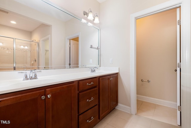 921 Rosepine Dr, Cary, NC 27519 - bathroom featuring double vanity, tile patterned flooring, and a tile shower
