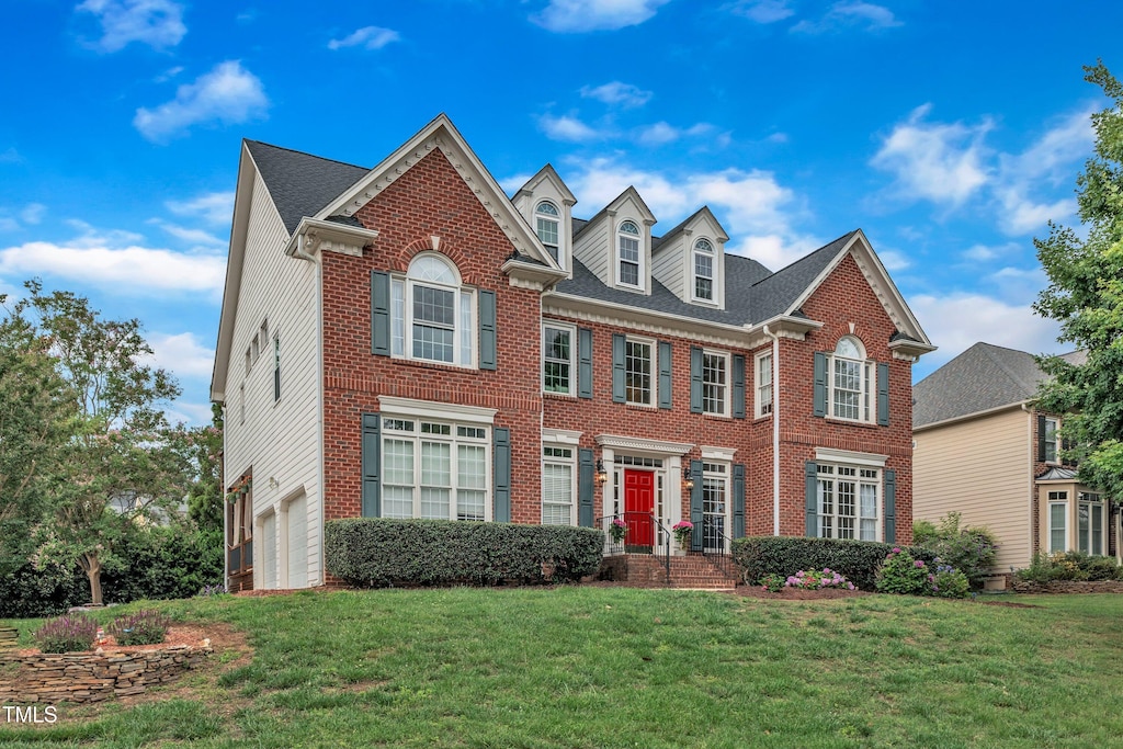 2224 Narrawood St, Raleigh, NC 27614 - colonial house featuring brick siding, a garage, and a front yard