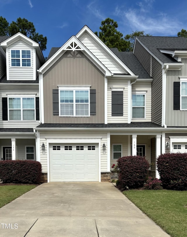 166 Gulley Glen Dr, Garner, NC 27529 - view of front facade with driveway, board and batten siding, a garage, and a porch