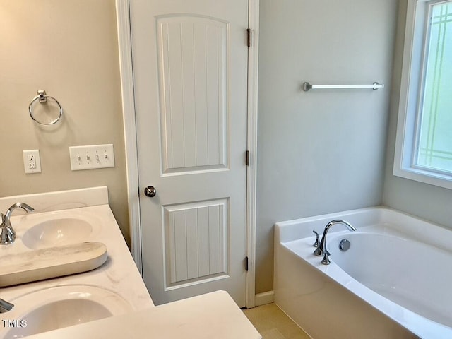 166 Gulley Glen Dr, Garner, NC 27529 - full bath featuring a garden tub, double vanity, and tile patterned floors
