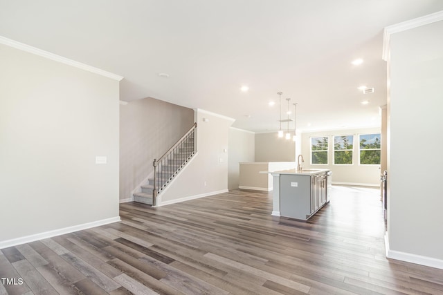 591 Traditions Grande Blvd, Wake Forest, NC 27587 - unfurnished living room featuring baseboards, ornamental molding, dark wood finished floors, recessed lighting, and stairway
