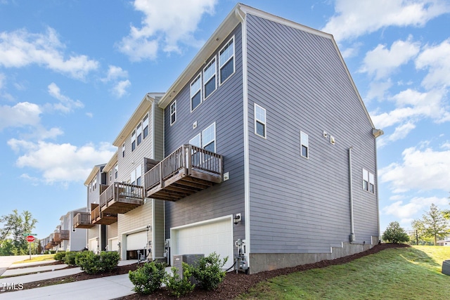 591 Traditions Grande Blvd, Wake Forest, NC 27587 - view of side of home featuring a garage, a lawn, and a balcony