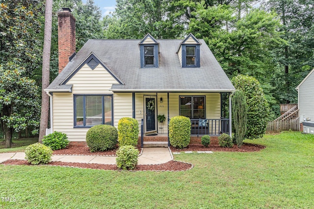 1426 Cedar Branch Ct, Wake Forest, NC 27587 - cape cod home featuring a porch, a front yard, and a chimney