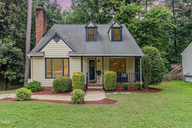 1426 Cedar Branch Ct, Wake Forest, NC 27587 - new england style home featuring a porch, a front yard, and a chimney