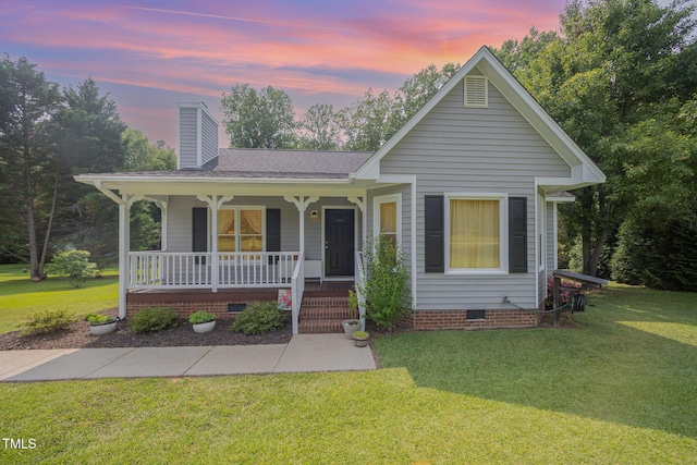 701 Creekside Dr, Clayton, NC 27520 - view of front facade featuring crawl space, a porch, a chimney, a lawn, and roof with shingles