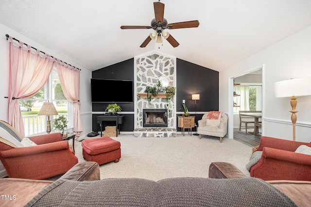 701 Creekside Dr, Clayton, NC 27520 - living area featuring a stone fireplace, ceiling fan, lofted ceiling, and healthy amount of natural light