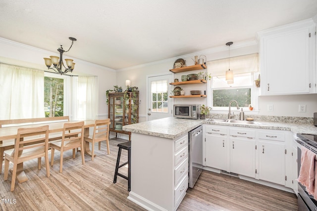 701 Creekside Dr, Clayton, NC 27520 - kitchen featuring stainless steel appliances, a sink, a chandelier, light wood finished floors, and light countertops