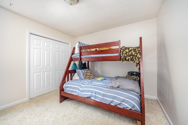 701 Creekside Dr, Clayton, NC 27520 - bedroom featuring carpet floors, a closet, baseboards, and a textured ceiling