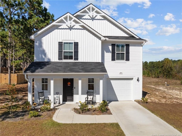 259 Desert Orchid Cir, Raeford, NC 28376 - view of front facade featuring board and batten siding, covered porch, a garage, driveway, and roof with shingles