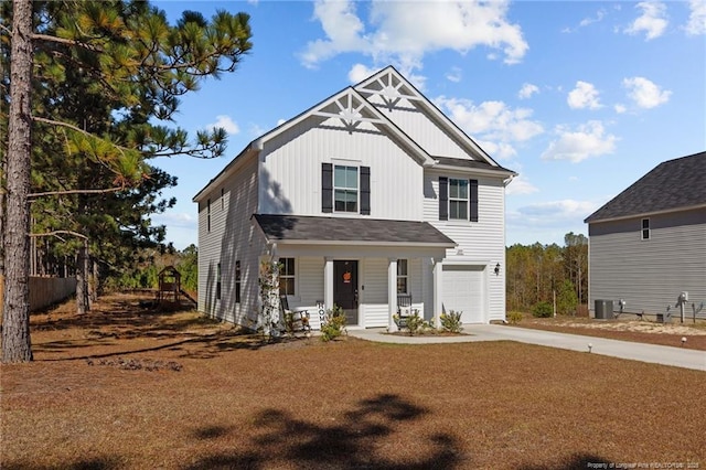 259 Desert Orchid Cir, Raeford, NC 28376 - view of front facade with board and batten siding, concrete driveway, an attached garage, a porch, and central AC unit