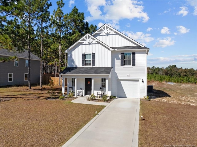 259 Desert Orchid Cir, Raeford, NC 28376 - view of front of house with board and batten siding, driveway, covered porch, and an attached garage