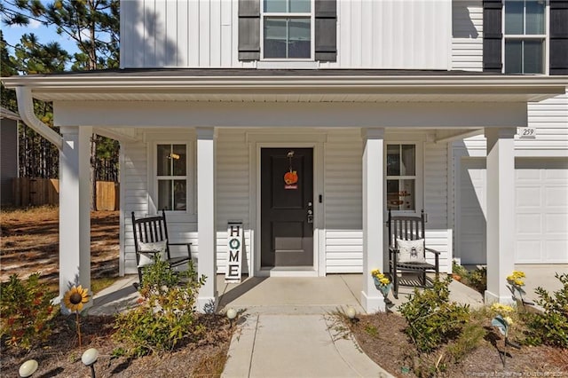 259 Desert Orchid Cir, Raeford, NC 28376 - doorway to property featuring a porch, board and batten siding, and a garage