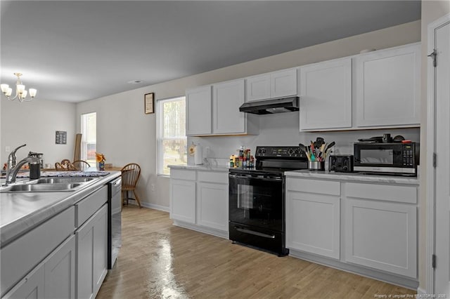259 Desert Orchid Cir, Raeford, NC 28376 - kitchen featuring stainless steel appliances, under cabinet range hood, a sink, a chandelier, and light wood-style floors