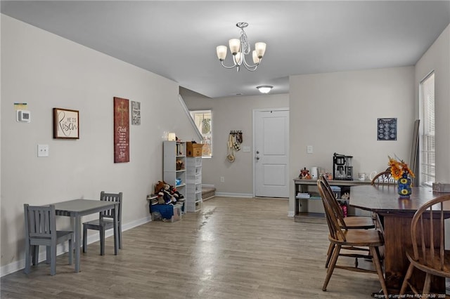 259 Desert Orchid Cir, Raeford, NC 28376 - dining area with a chandelier, baseboards, and wood finished floors