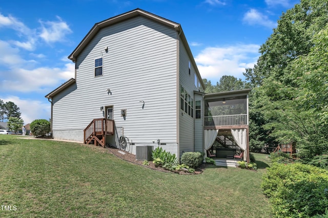 6509 Conaway Ct, Wake Forest, NC 27587 - rear view of house featuring a sunroom, a lawn, and central AC unit