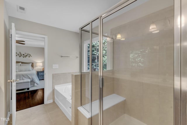 6509 Conaway Ct, Wake Forest, NC 27587 - ensuite bathroom featuring tile patterned floors, a garden tub, and a shower stall