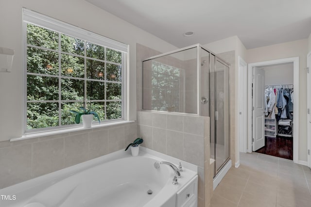6509 Conaway Ct, Wake Forest, NC 27587 - full bathroom featuring plenty of natural light, a garden tub, tile patterned flooring, and a shower stall