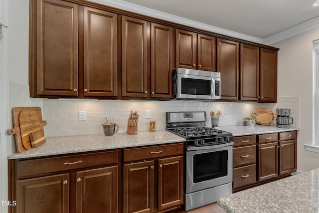 6509 Conaway Ct, Wake Forest, NC 27587 - kitchen featuring appliances with stainless steel finishes, crown molding, decorative backsplash, wood finished floors, and dark brown cabinets