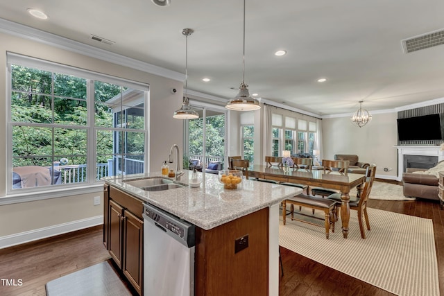 6509 Conaway Ct, Wake Forest, NC 27587 - kitchen featuring dishwasher, a sink, open floor plan, crown molding, and baseboards