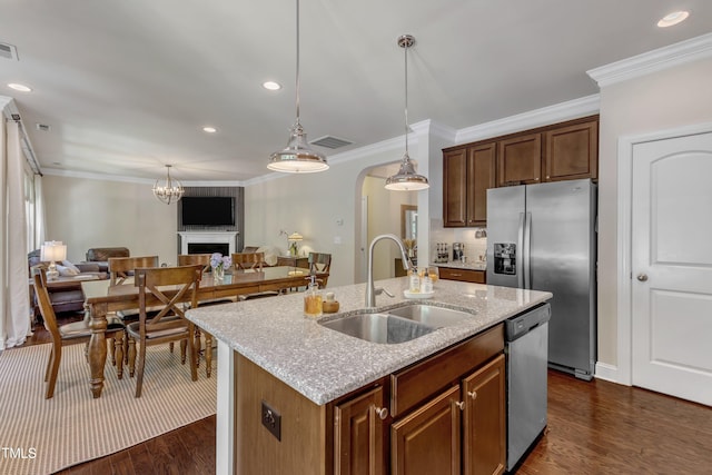 6509 Conaway Ct, Wake Forest, NC 27587 - kitchen with a sink, appliances with stainless steel finishes, open floor plan, arched walkways, and dark wood-style floors