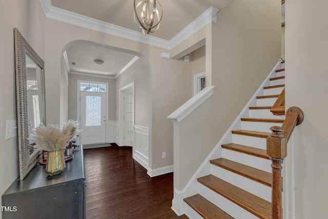 6509 Conaway Ct, Wake Forest, NC 27587 - entryway featuring arched walkways, crown molding, dark wood finished floors, stairs, and a chandelier