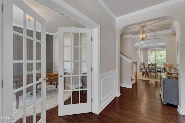 6509 Conaway Ct, Wake Forest, NC 27587 - hall with arched walkways, dark wood-style flooring, ornamental molding, french doors, and a wainscoted wall